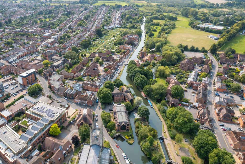 Knights completes on acquisition to expand South of England presence - A view of a city with a river running through it.