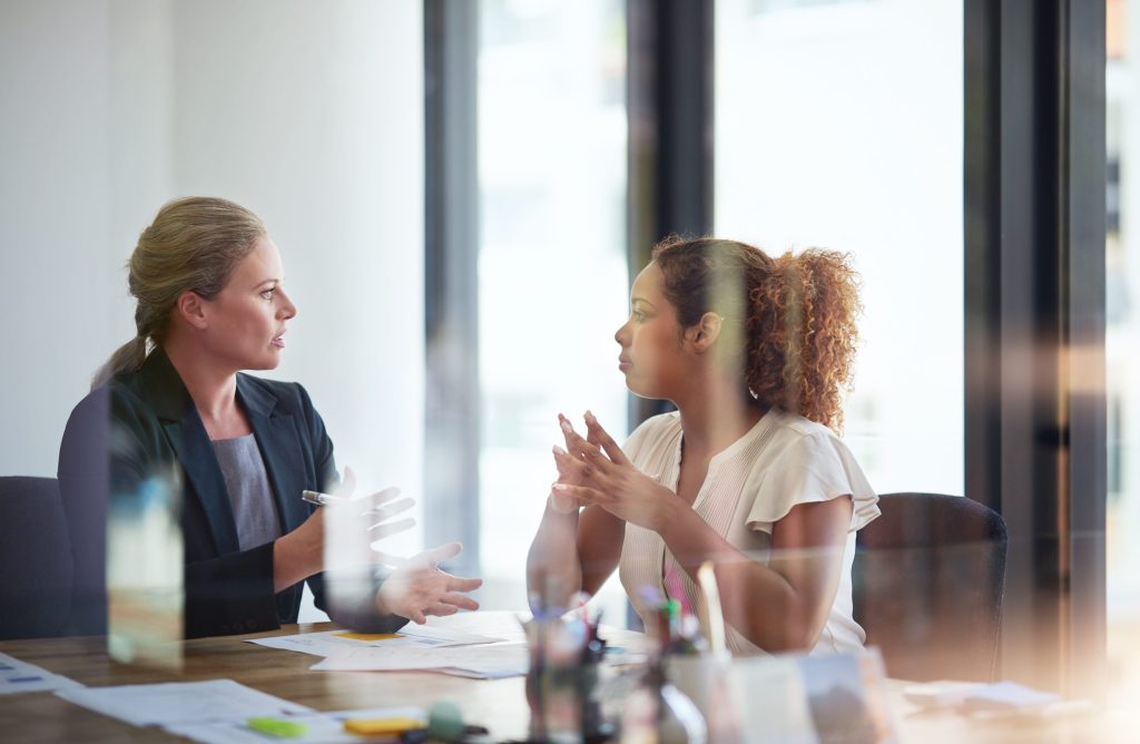 Knights Legal Services - Three women sitting at a table in front of a window.