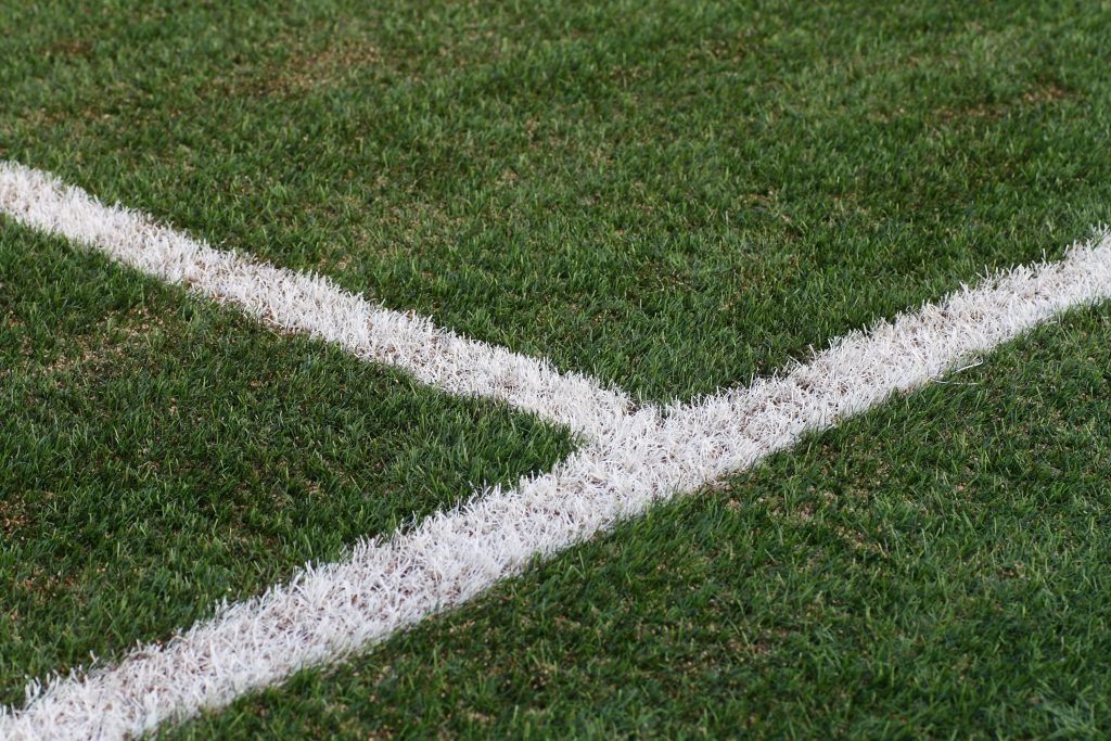 Knights Legal Services - a close up of a soccer field with a white line on it