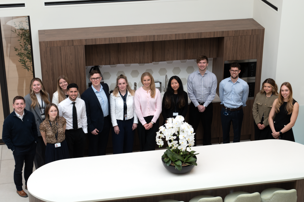 Knights celebrates 12 newly-qualified professionals - A group of people posing for a picture in a lobby.