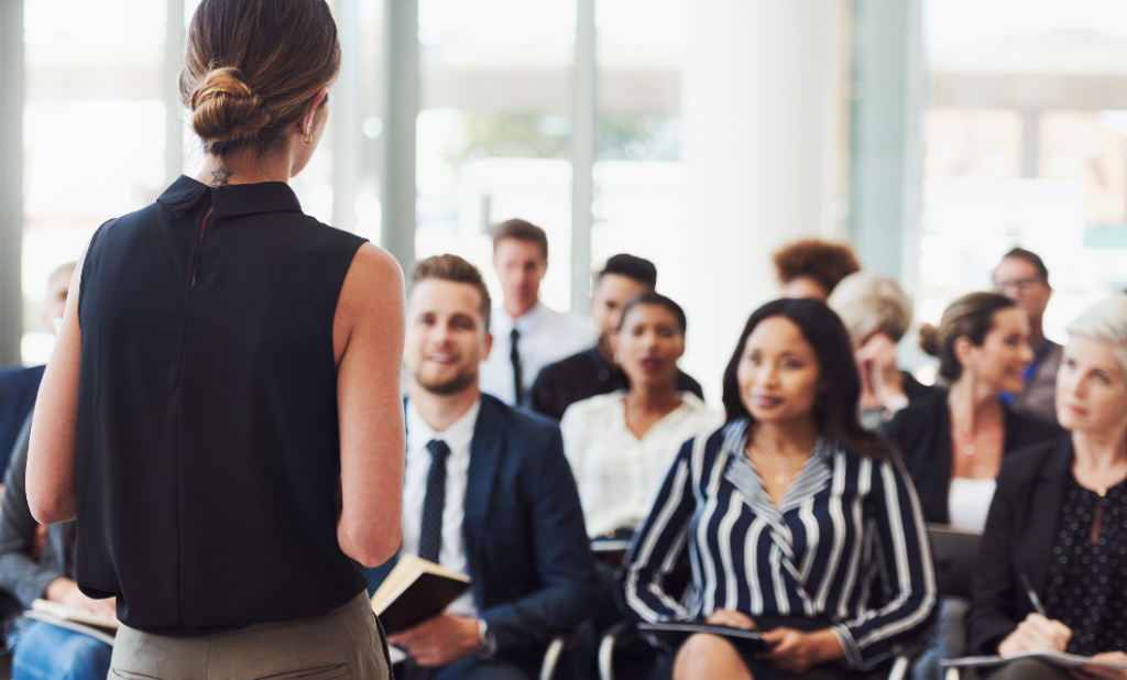 Knights Legal Services - A woman standing in front of a group of people.